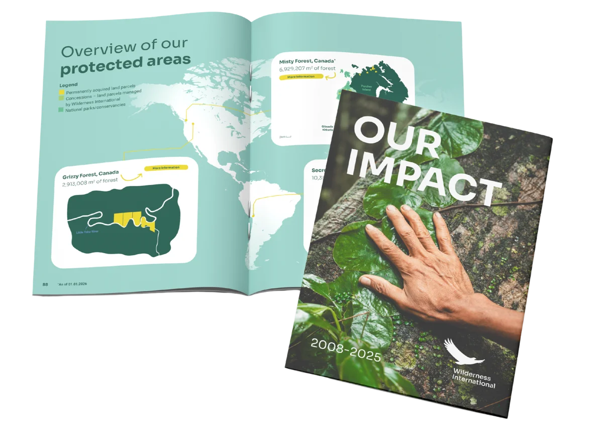 Open magazine displaying an overview map of protected forest areas in Canada and the US, alongside a 